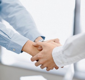 Businessmen Shaking Hands --- Image by © Bloomimage/Corbis